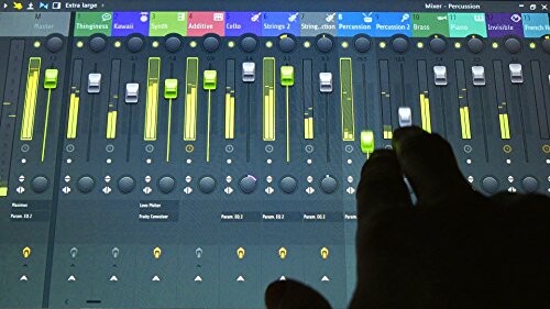 Hand adjusting audio mixing console sliders on screen.