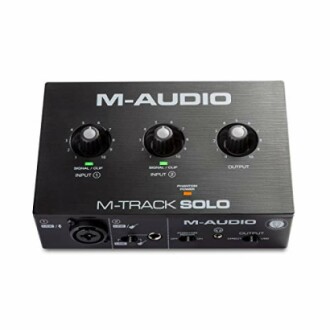M-Audio M-Track Solo audio interface with control knobs and inputs.