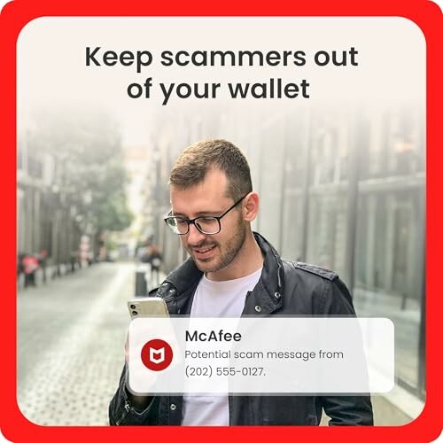 Man looking at phone with scam alert notification.
