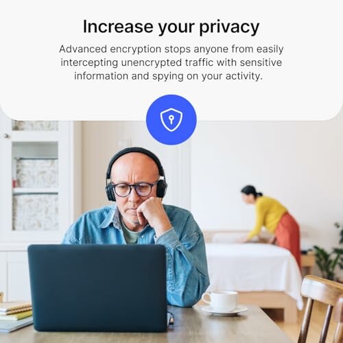 Man with headphones using laptop, privacy message displayed.